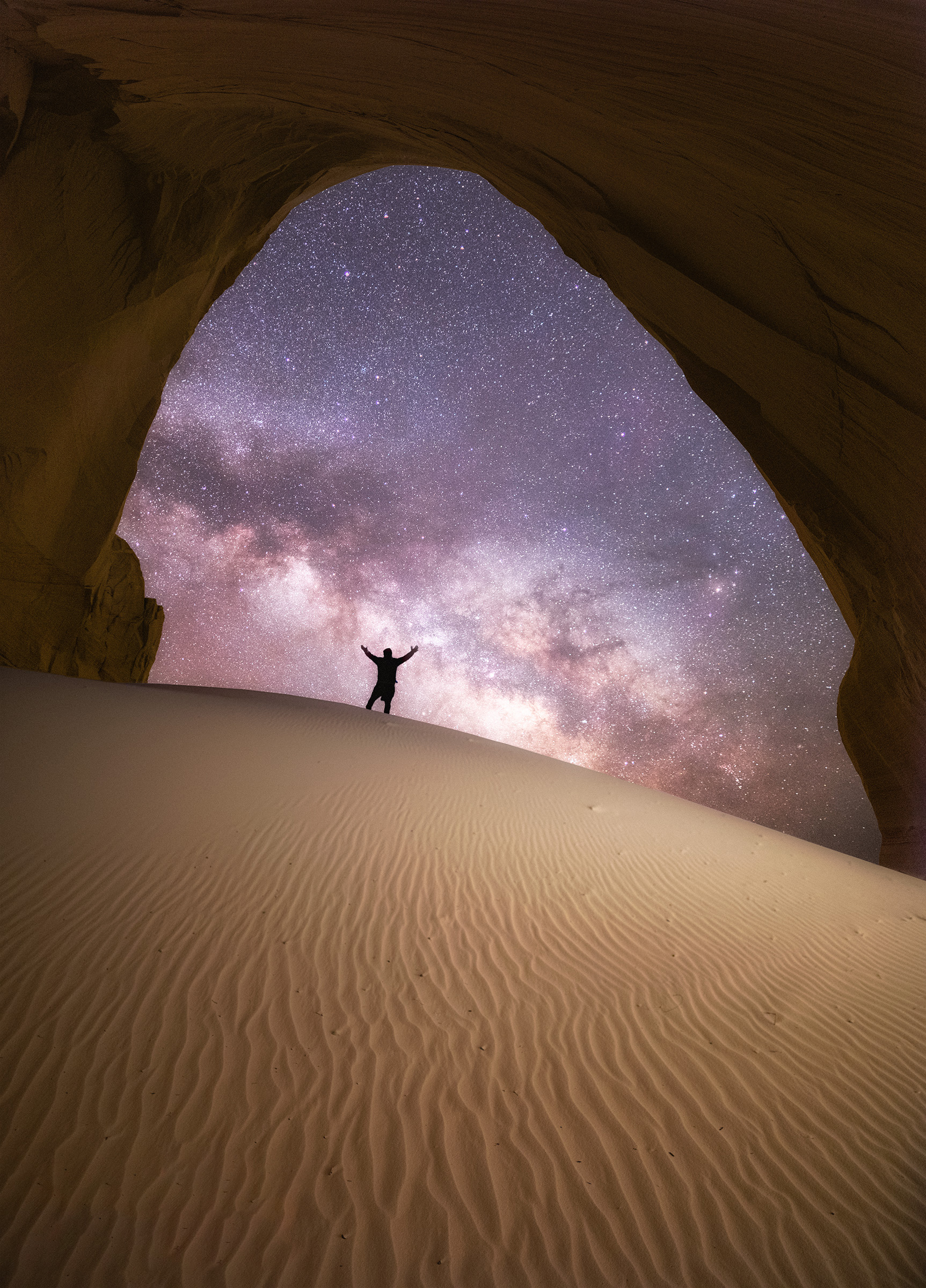Milky Way over a glowing sand cave photographed by Aaron King